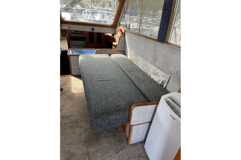 Slide: The Image of 1973 Uniflite Sport Fisher interior with gray sofa and window blinds. - 60