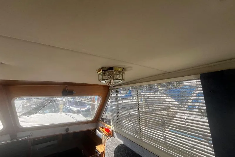 Slide: The Image of Interior of 1973 Uniflite Sport Fisher boat with window blinds and ceiling light fixture. - 61