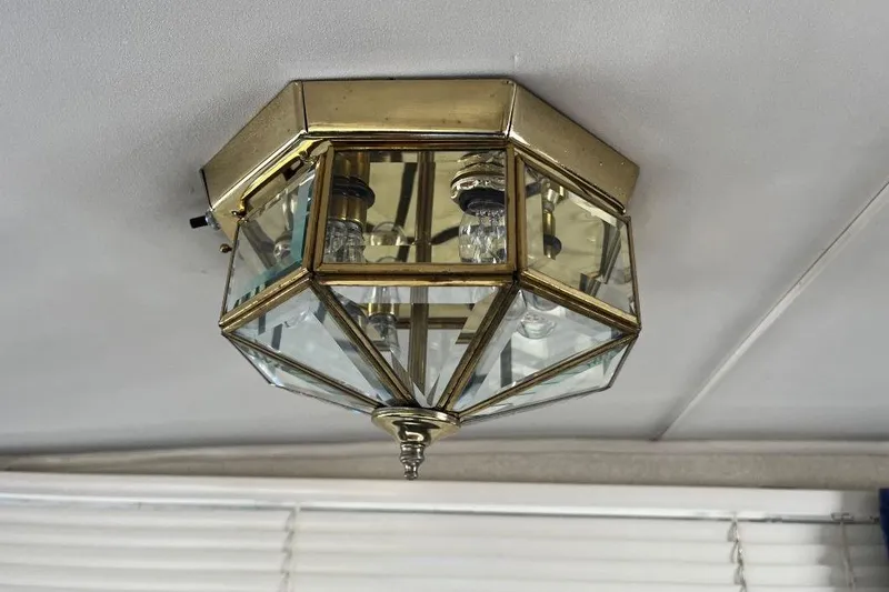 Slide: The Image of Vintage brass ceiling light fixture on 1973 Uniflite Sport Fisher boat. - 62
