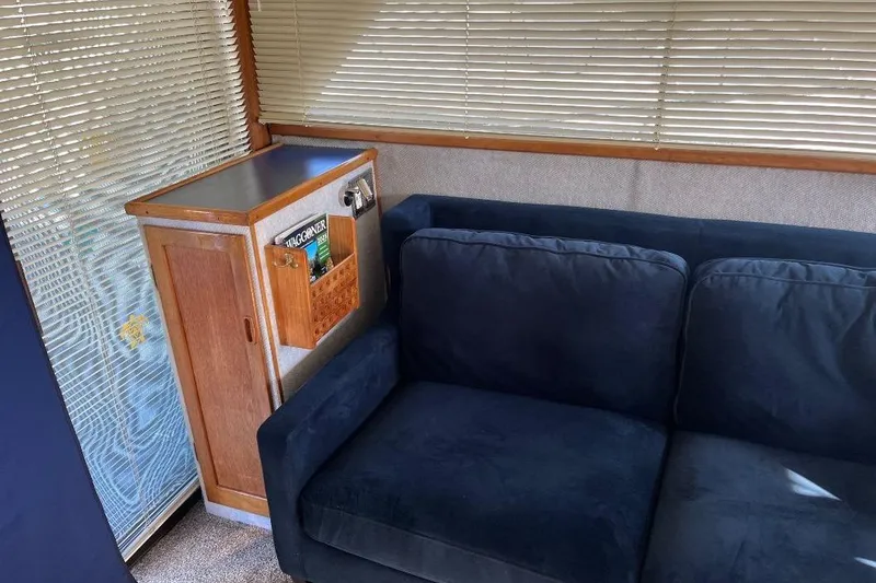 Slide: The Image of Interior of 1973 Uniflite Sport Fisher with blue sofa and wooden cabinet. - 65