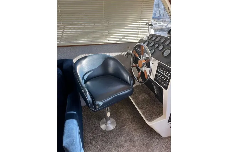 Slide: The Image of 1973 Uniflite Sport Fisher helm with leather chair and classic wooden steering wheel. - 70