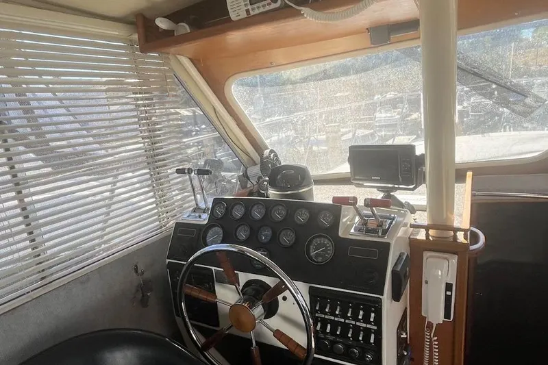 Slide: The Image of 1973 Uniflite Sport Fisher boat interior with steering wheel, gauges, and navigation equipment. - 71