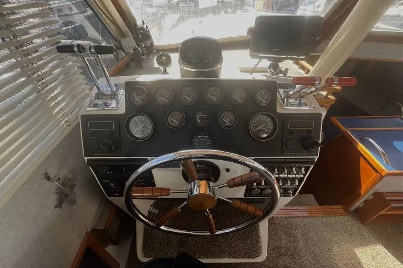Slide: The Image of 1973 Uniflite Sport Fisher helm with gauges, steering wheel, and navigation equipment. - 73