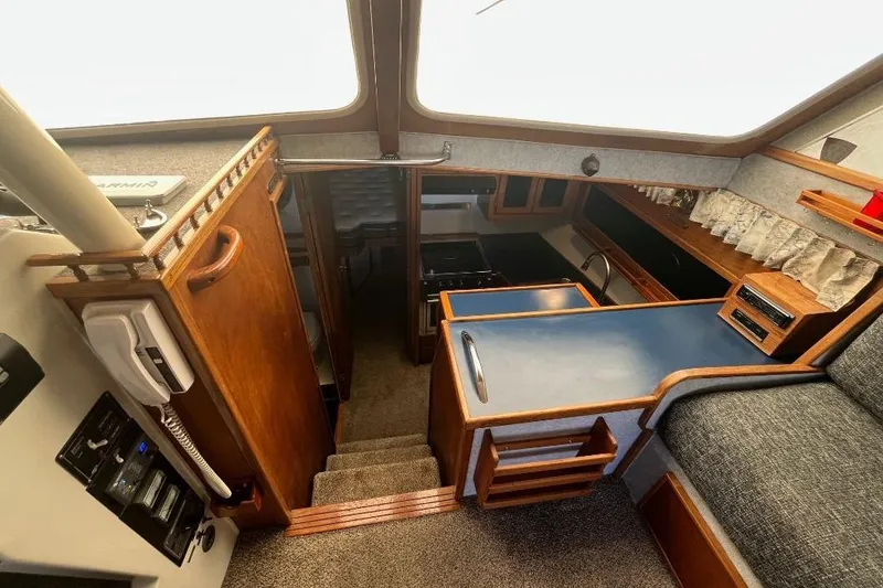 Slide: The Image of Interior of a 1973 Uniflite Sport Fisher boat, featuring a compact kitchen and seating area. - 75