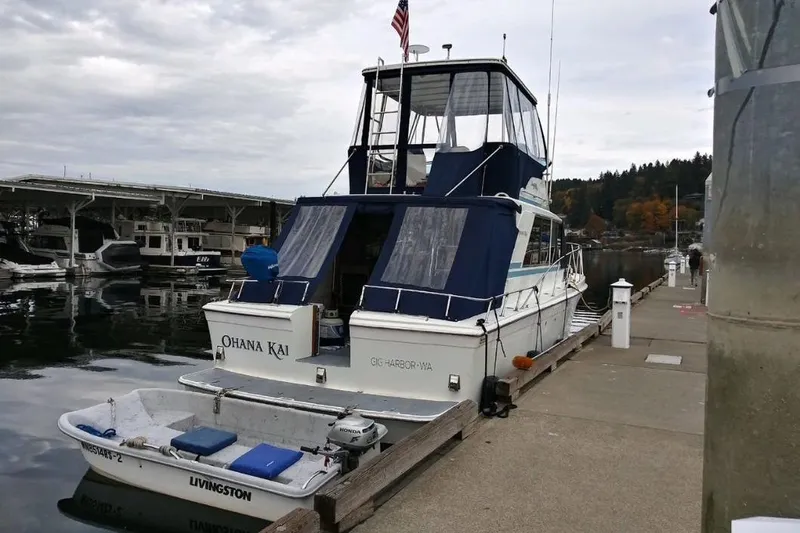 Slide: The Image of 1973 Uniflite Sport Fisher boat docked at marina, featuring blue canvas covers. - 8