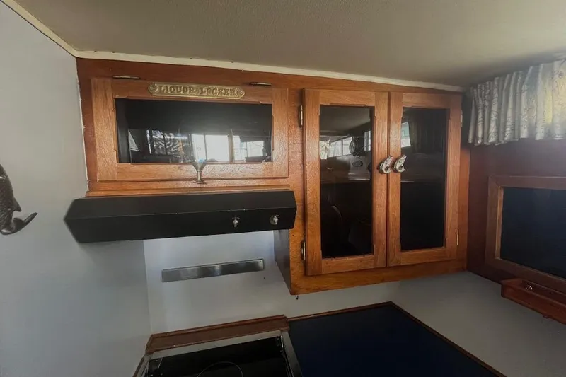 Slide: The Image of 1973 Uniflite Sport Fisher interior with wooden cabinets and vintage decor. - 84