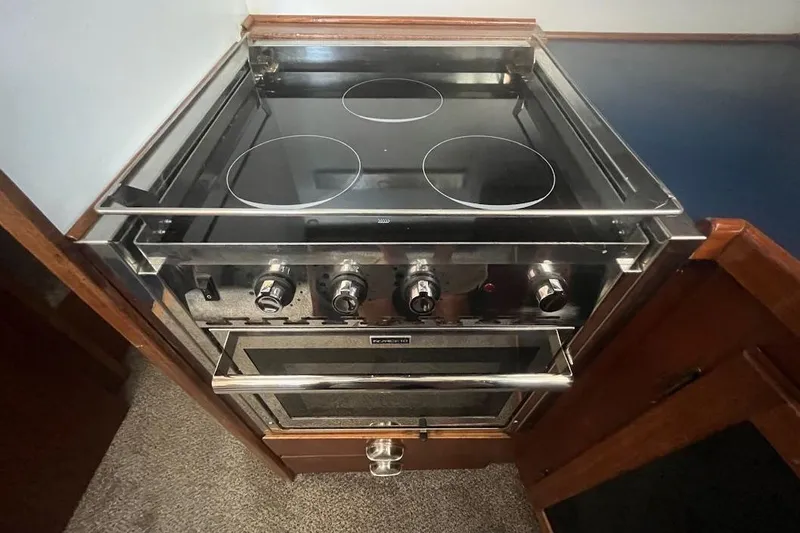 Slide: The Image of 1973 Uniflite Sport Fisher kitchen stove with four burners and oven, stainless steel finish. - 86
