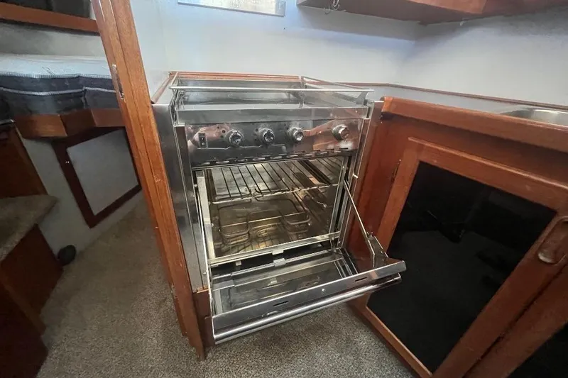 Slide: The Image of 1973 Uniflite Sport Fisher kitchen with stainless steel oven and wooden cabinetry. - 87