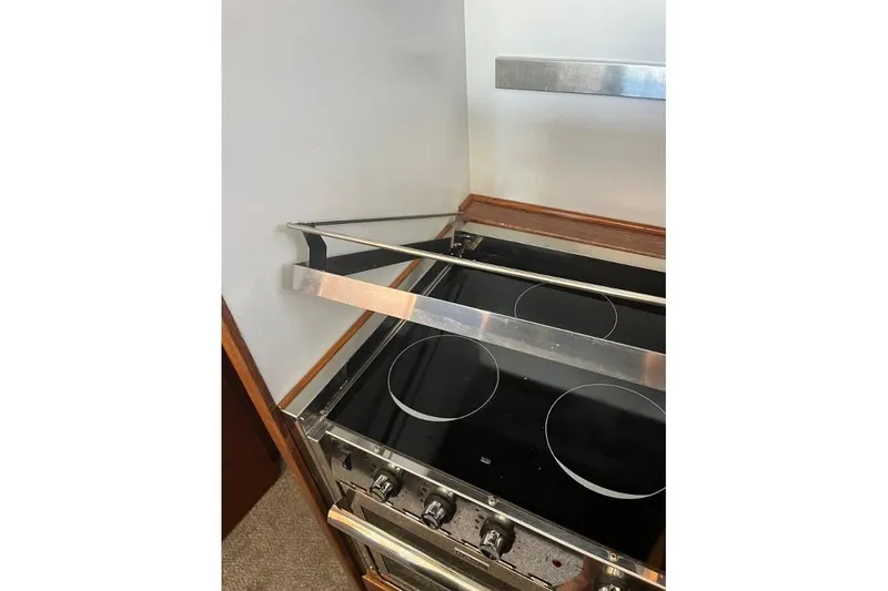 Slide: The Image of 1973 Uniflite Sport Fisher kitchen stove with four burners and safety rail. - 88
