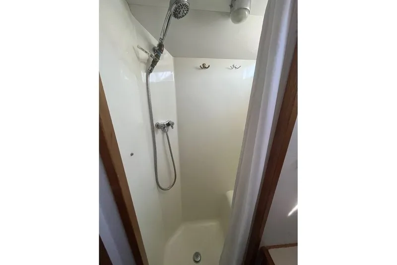 Slide: The Image of 1973 Uniflite Sport Fisher shower with handheld showerhead and white curtain. - 95