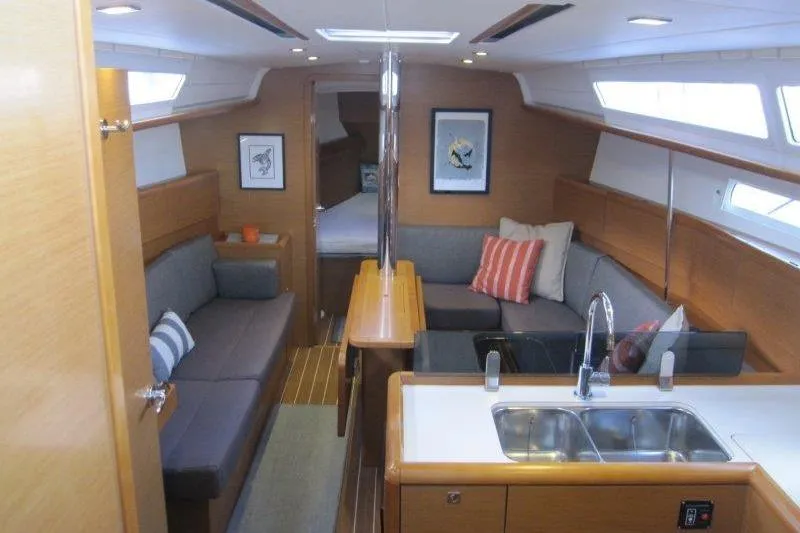 Slide: The Image of Interior of 2013 Jeanneau 379 sailboat with modern seating and kitchen area. - 1