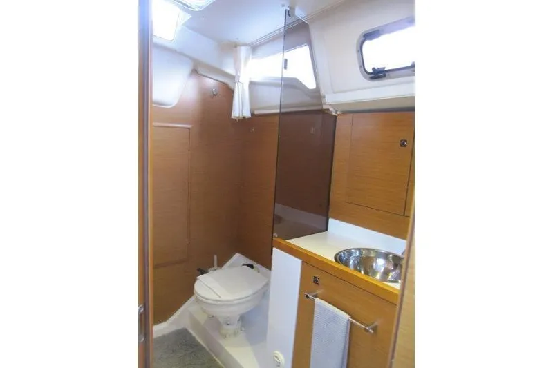 Slide: The Image of 2013 Jeanneau 379 yacht bathroom with modern fixtures and wooden cabinetry. - 20