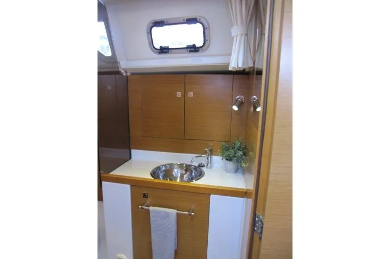 Slide: The Image of Interior of 2013 Jeanneau 379 sailboat bathroom with sink and storage cabinets. - 21