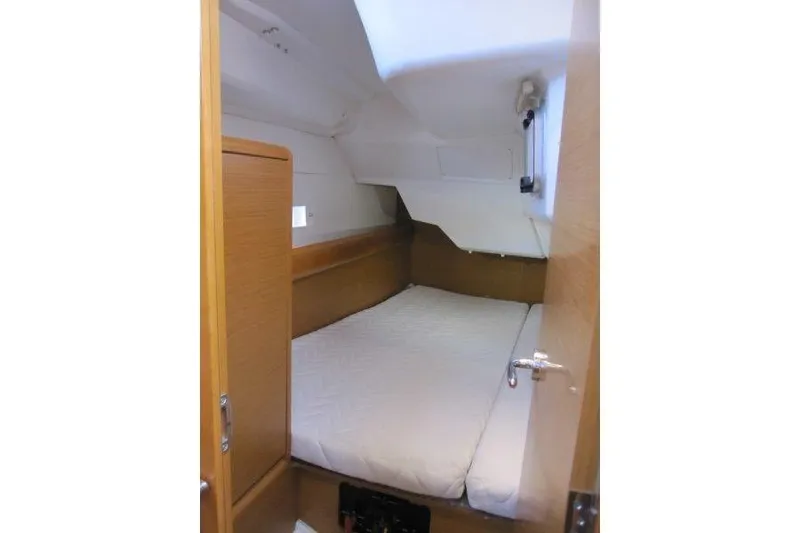 Slide: The Image of 2013 Jeanneau 379 cabin interior with cozy bed and wooden finish. - 25