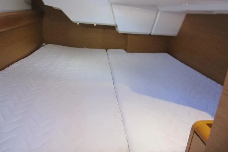 Slide: The Image of 2013 Jeanneau 379 yacht cabin with twin beds and wooden interior. - 26