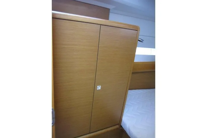 Slide: The Image of 2013 Jeanneau 379 interior cabin with wooden wardrobe and bed. - 27