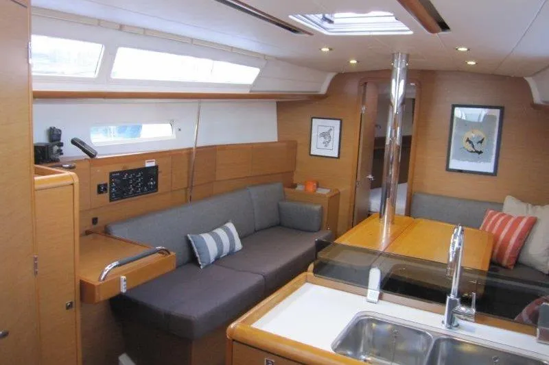 Slide: The Image of Interior of 2013 Jeanneau 379 sailboat with modern seating and kitchen area. - 28