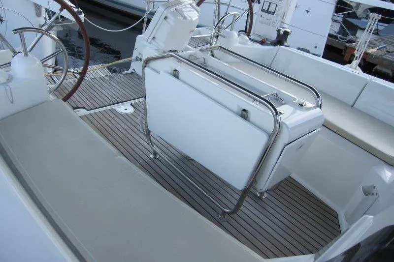 Slide: The Image of 2013 Jeanneau 379 sailboat cockpit with dual steering wheels and teak flooring. - 40