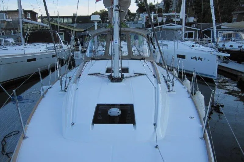 Slide: The Image of 2013 Jeanneau 379 sailboat docked at marina, showcasing sleek deck design. - 45
