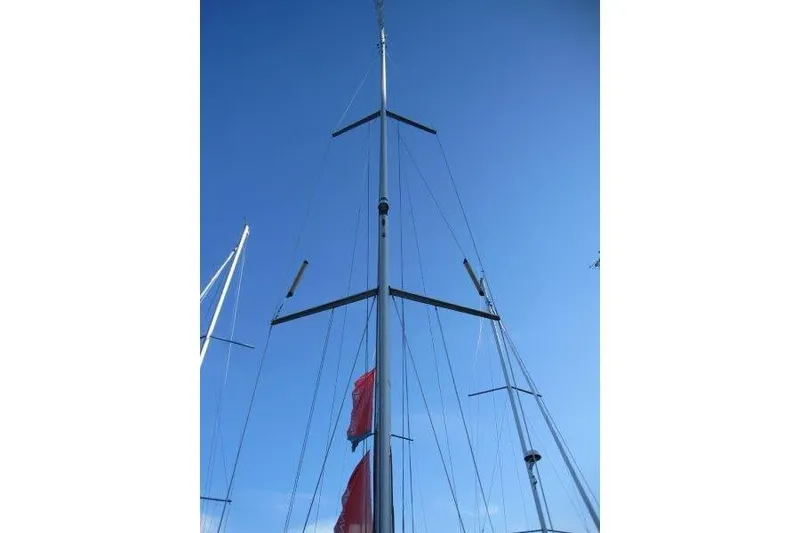 Slide: The Image of Tall mast of a 2013 Jeanneau 379 sailboat against a clear blue sky. - 46