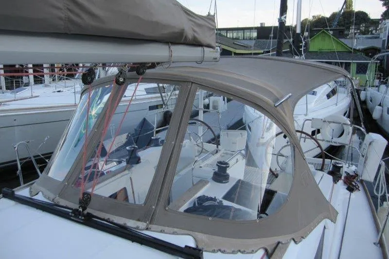 Slide: The Image of 2013 Jeanneau 379 sailboat with beige canopy docked at marina. - 47
