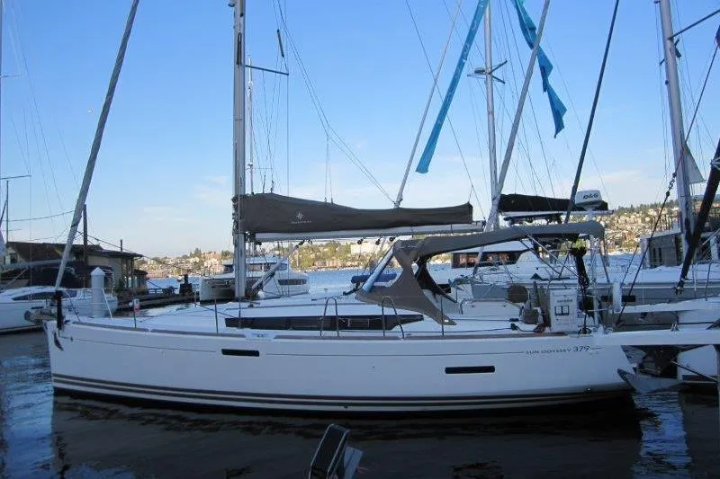 Slide: The Image of 2013 Jeanneau 379 sailboat docked in a marina, with clear blue sky. - 50
