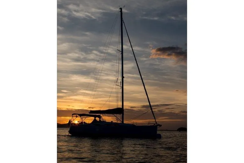 Slide: The Image of Sailboat Jeanneau 379 silhouetted against a stunning sunset, 2013 model. - 52