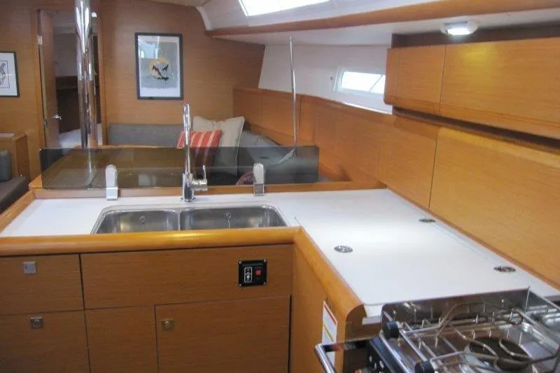 Slide: The Image of Interior of 2013 Jeanneau 379 yacht featuring modern kitchen and cozy seating area. - 9