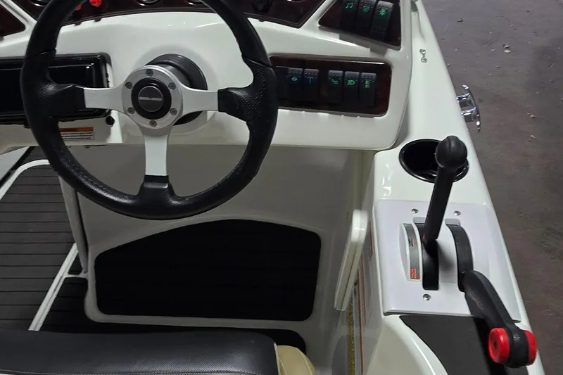 Slide: The Image of 2007 Sea-Doo Islandia SE boat dashboard with steering wheel and control lever. - 12
