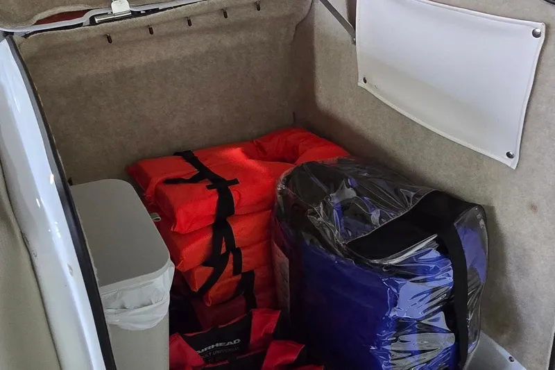 Slide: The Image of Storage compartment in 2007 Sea-Doo Islandia SE with life jackets and gear. - 16