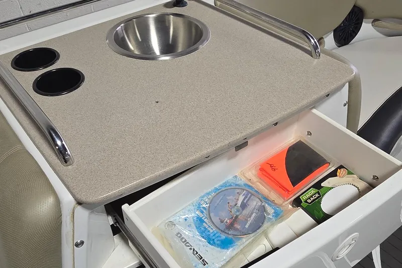 Slide: The Image of 2007 Sea-Doo Islandia SE boat interior with sink, cup holders, and storage drawer. - 18