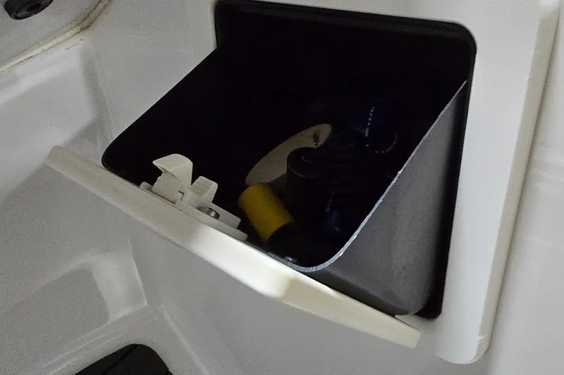 Slide: The Image of Storage compartment in 2007 Sea-Doo Islandia SE boat, containing various items. - 21