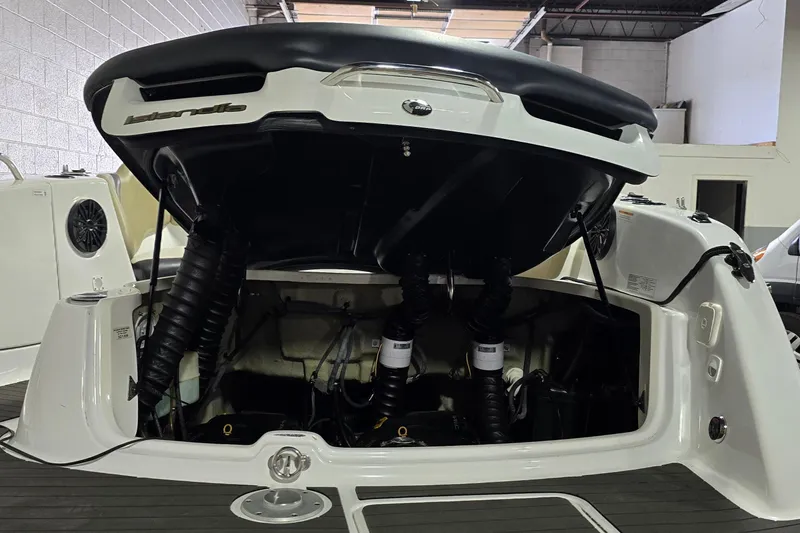 Slide: The Image of 2007 Sea-Doo Islandia SE boat engine compartment with open hatch in a garage setting. - 26