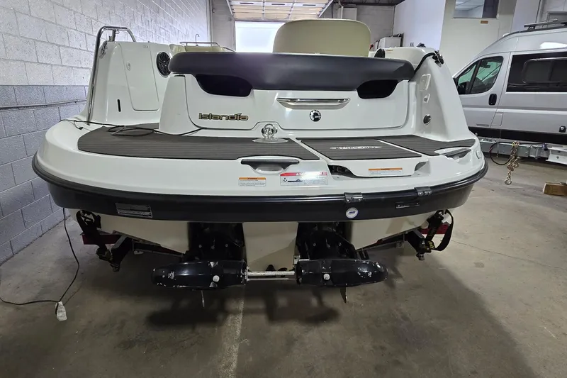 Slide: The Image of 2007 Sea-Doo Islandia SE boat in a garage, rear view showing deck and engines. - 5