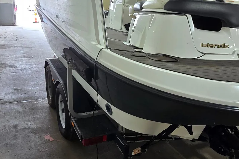 Slide: The Image of 2007 Sea-Doo Islandia SE boat on trailer in garage setting. - 6