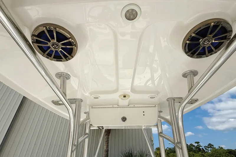 Slide: The Image of 2015 Sportsman Heritage 231 Center Console boat interior with white cushioned seating. - 11
