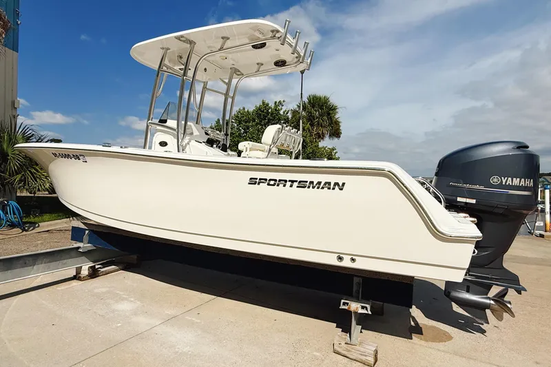 Slide: The Image of 2015 Sportsman Heritage 231 Center Console boat docked in a marina. - 2