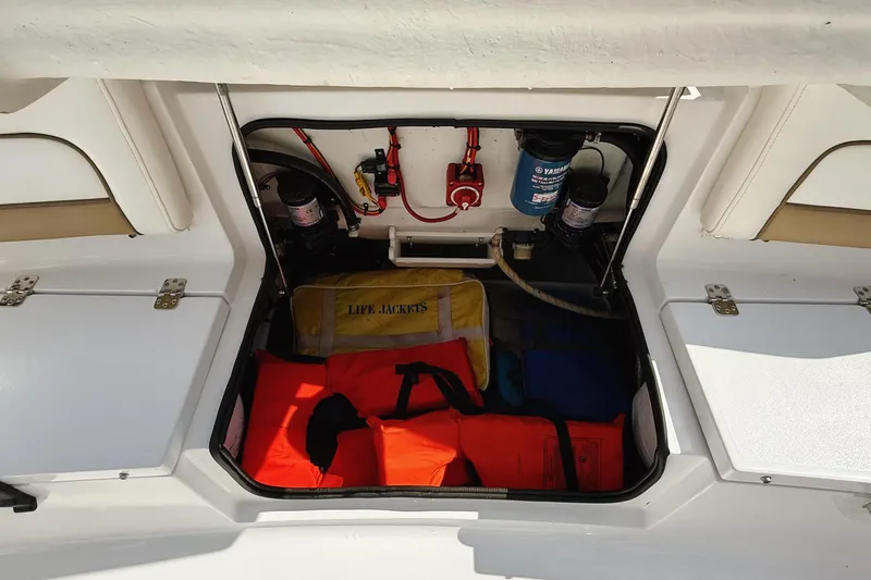 Slide: The Image of Storage compartment of 2015 Sportsman Heritage 231 Center Console with life jackets and equipment. - 29