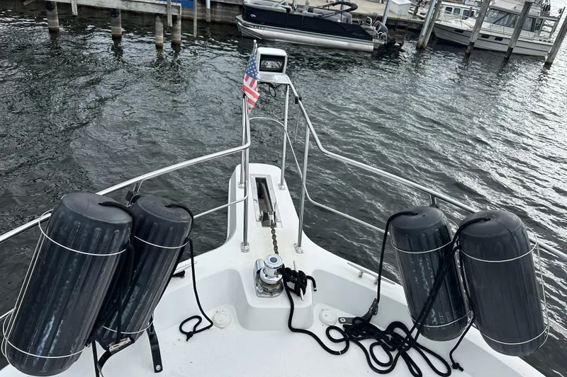 Slide: The Image of 1998 Carver 445 Aft Cabin Motor Yacht docked at marina under cloudy sky. - 14