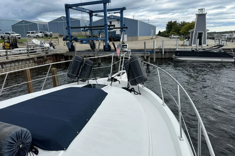 Slide: The Image of 1998 Carver 445 Aft Cabin Motor Yacht docked under cloudy skies. - 15