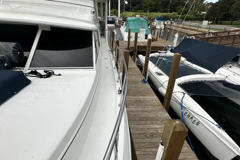Slide: The Image of 1998 Carver 445 Aft Cabin Motor Yacht docked, featuring "Summer Breeze" name and inflatable boat. - 18