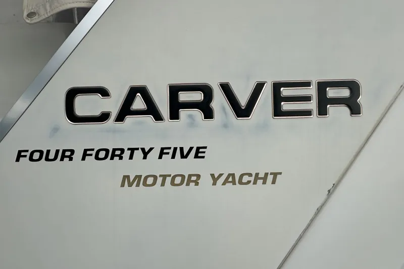 Slide: The Image of 1998 Carver 445 Aft Cabin Motor Yacht docked at a marina, view of the bow. - 23