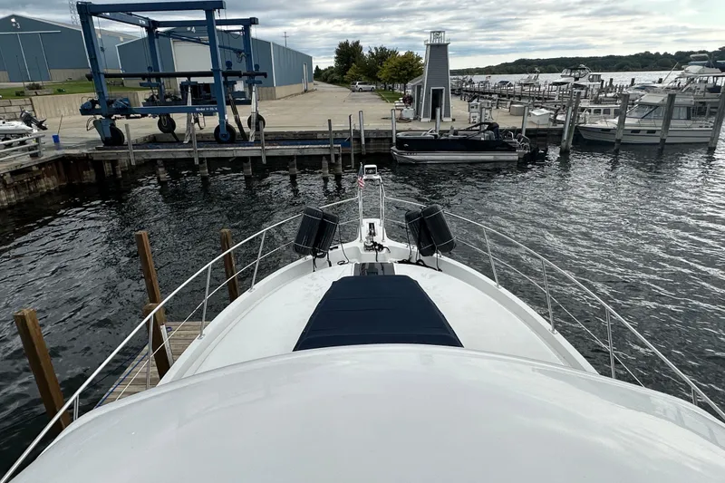 Slide: The Image of 1998 Carver 445 Aft Cabin Motor Yacht docked, featuring spacious deck and sleek design. - 26