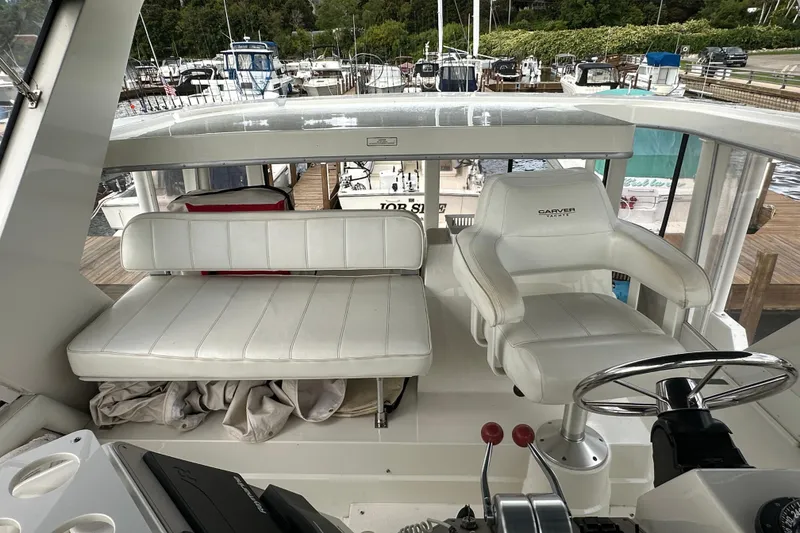 Slide: The Image of 1998 Carver 445 Aft Cabin Motor Yacht docked alongside other boats. - 29
