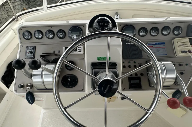 Slide: The Image of 1998 Carver 445 Aft Cabin Motor Yacht docked under cloudy skies. - 30