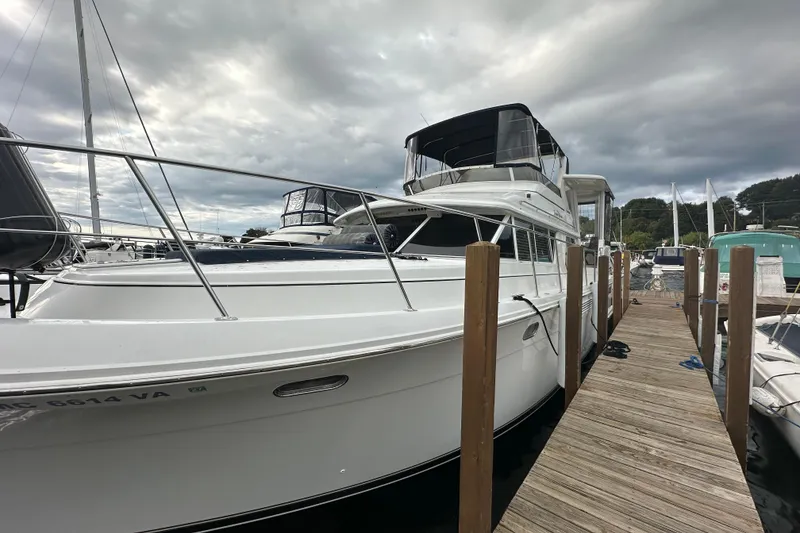 Slide: The Image of 1998 Carver 445 Aft Cabin Motor Yacht on dry dock under sunny sky. - 4