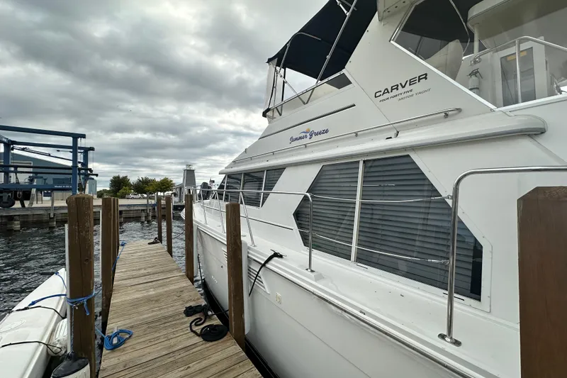 Slide: The Image of 1998 Carver 445 Aft Cabin Motor Yacht on trailer under sunny sky. - 5