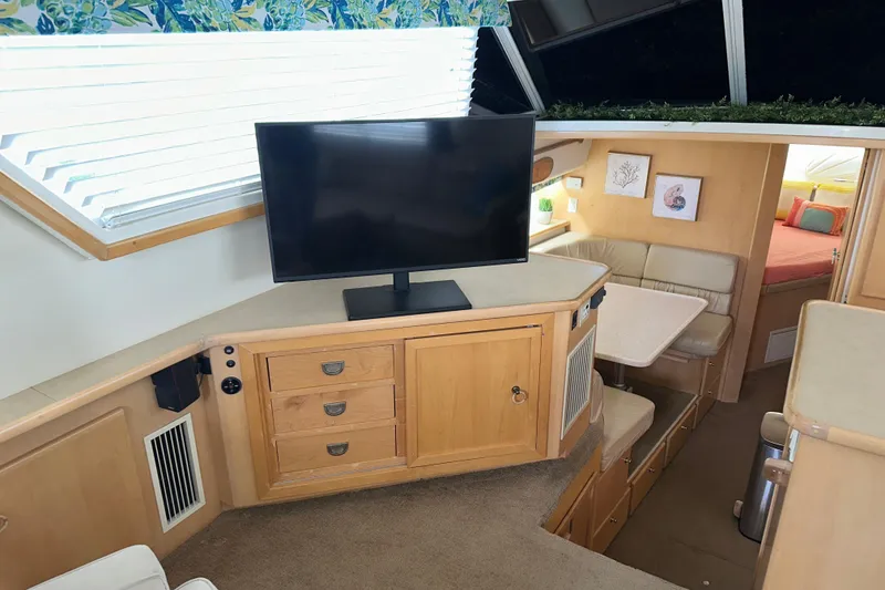 Slide: The Image of 1998 Carver 445 Aft Cabin Motor Yacht bedroom with cozy decor and mirrored closet. - 64