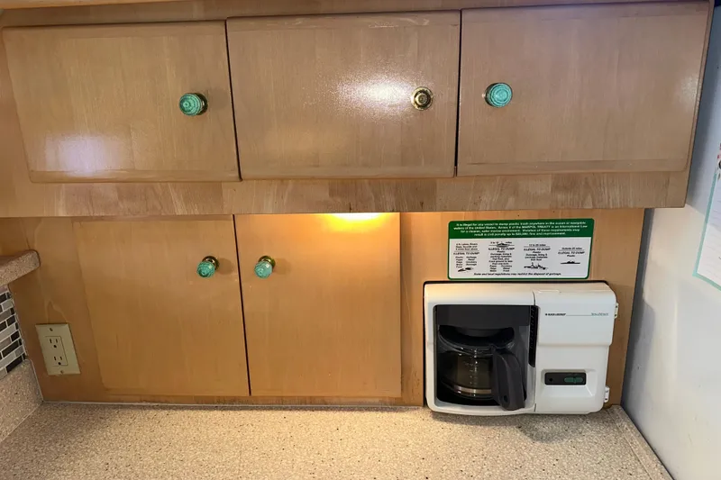 Slide: The Image of Interior of 1998 Carver 445 Aft Cabin Motor Yacht with kitchenette and cozy decor. - 74