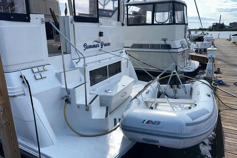 Slide: The Image of 1998 Carver 445 Aft Cabin Motor Yacht docked at a sunny marina. - 9